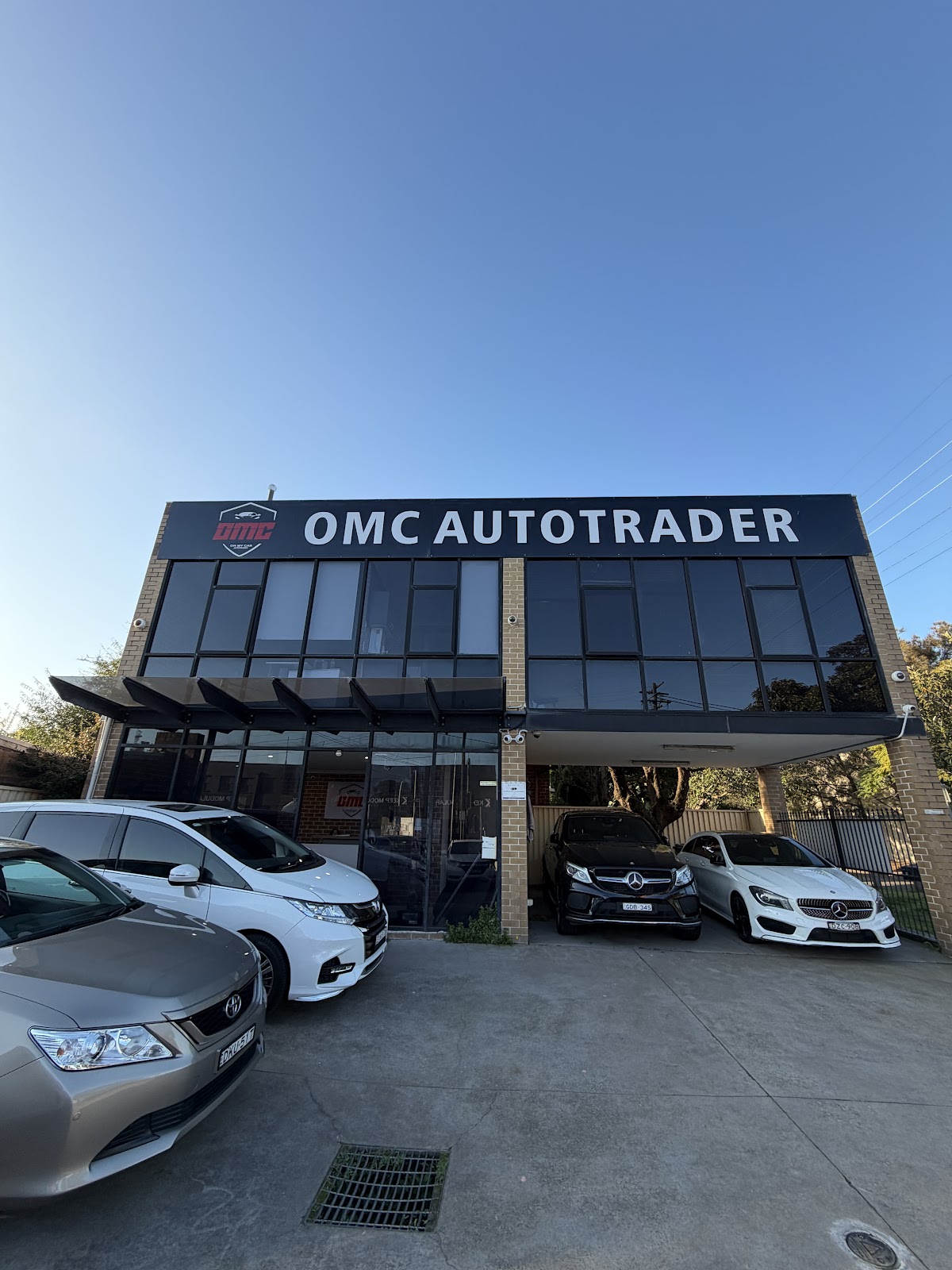 The OMC Autotrader building at 255 Parramatta Road, Five Dock, with cars parked across the front