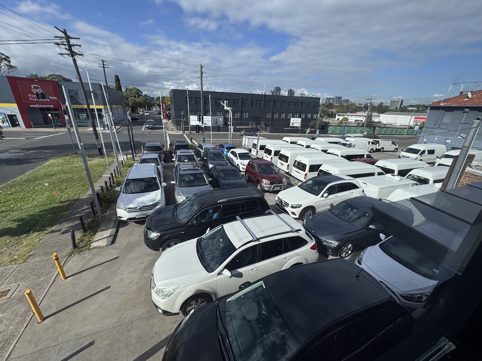 The OMC Autotrader forecourt at Five Dock seen from above, with cars parked in rows along Parramatta Road